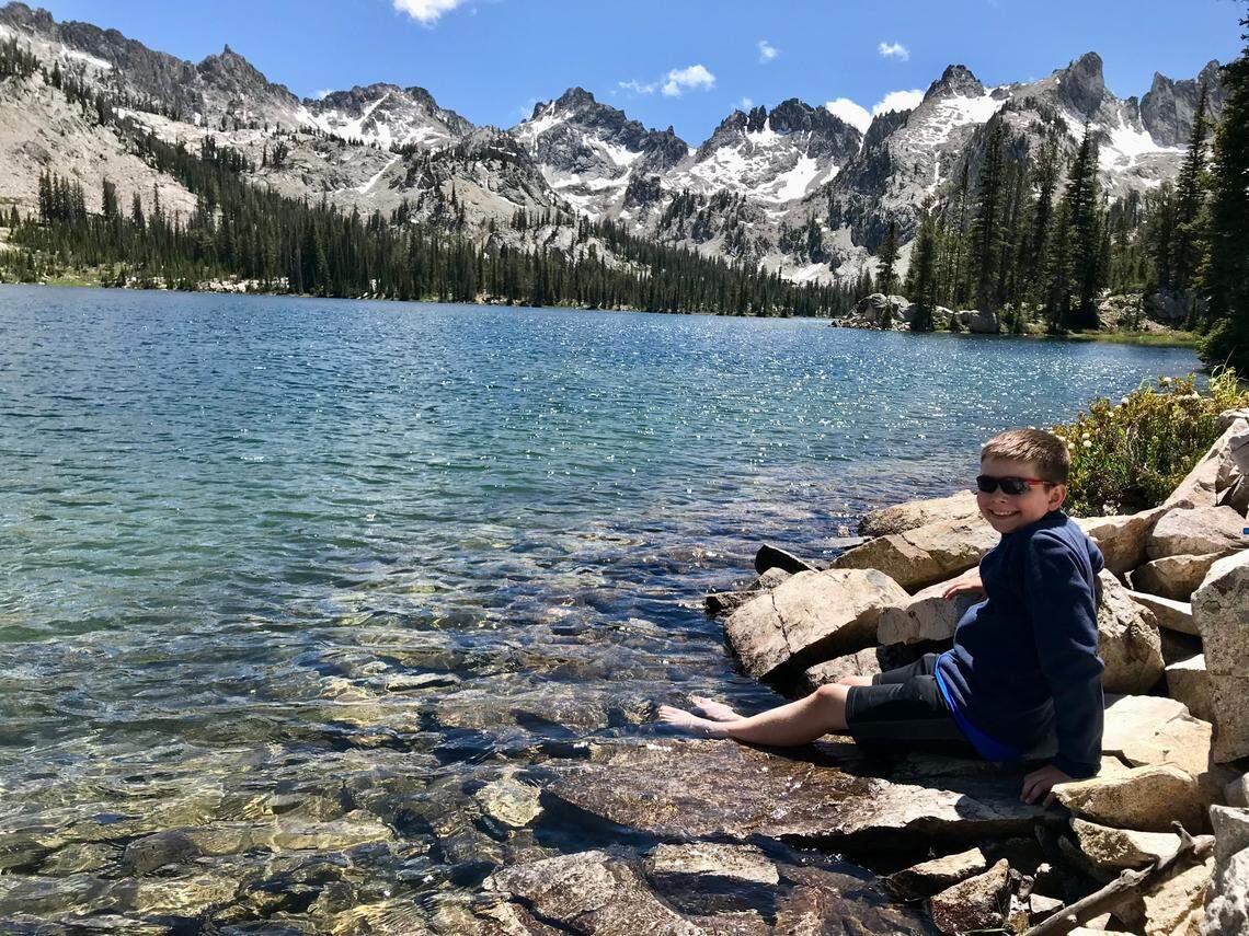 Oliver Cripe dips his feet in Alice Lake during a hike in the Sawtooth National Recreation Area in 2019.