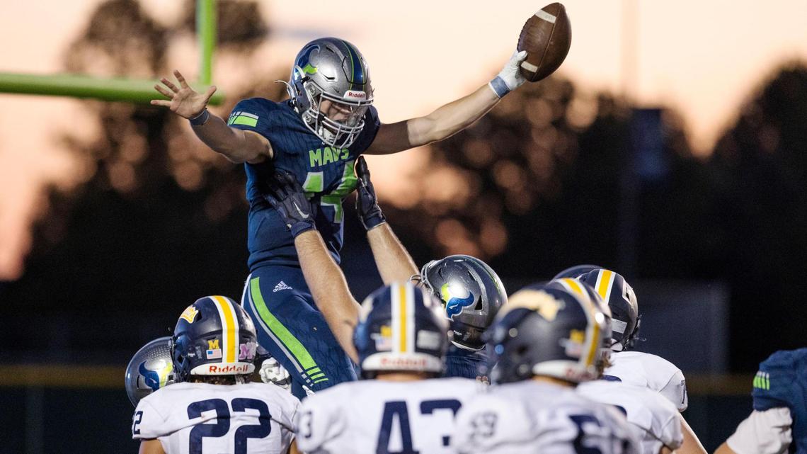 Mountain View quarterback Justin McGee is hoisted up in the air after running for a 7-yard touchdown Friday against Meridian. The Mavericks jumped out to a 17-0 lead before hanging on for a 31-26 win.