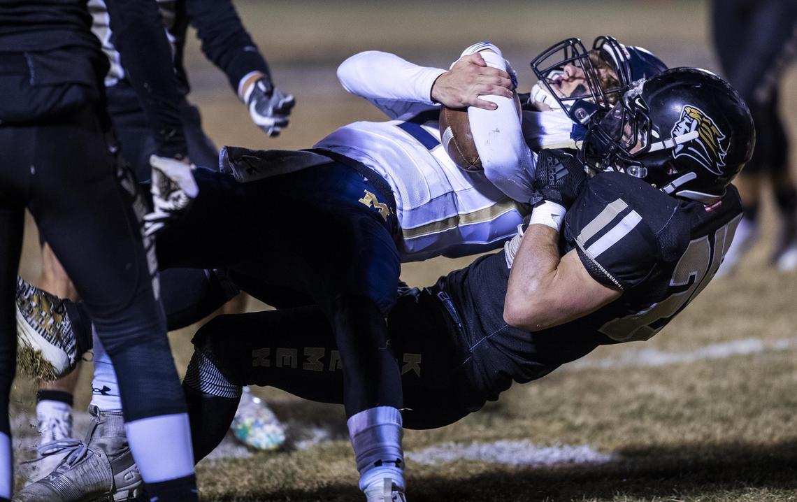 Kuna linebacker Austin Bunn pulls down Middleton quarterback Dallas Hagler in the second half Friday at Kuna High School.
