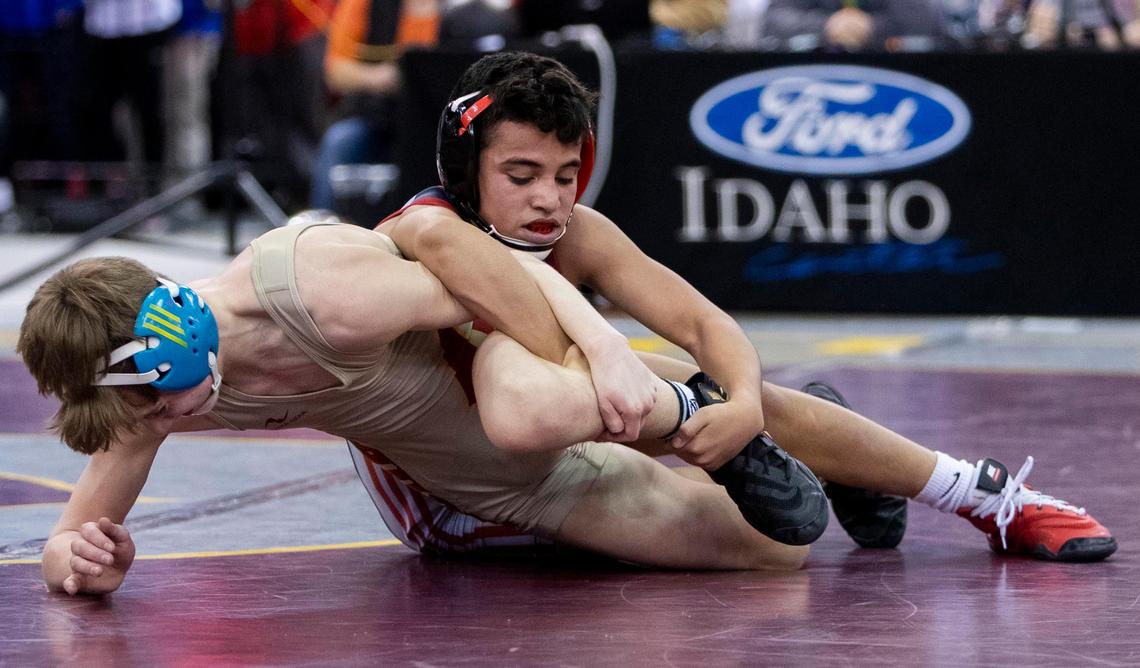 Dedrick Navarro, Nampa, works on Columbia’s Payton Hernandez during the 4A 98-pound state wrestling championship Saturday, Feb. 29, 2020 at Ford Idaho Center in Nampa.