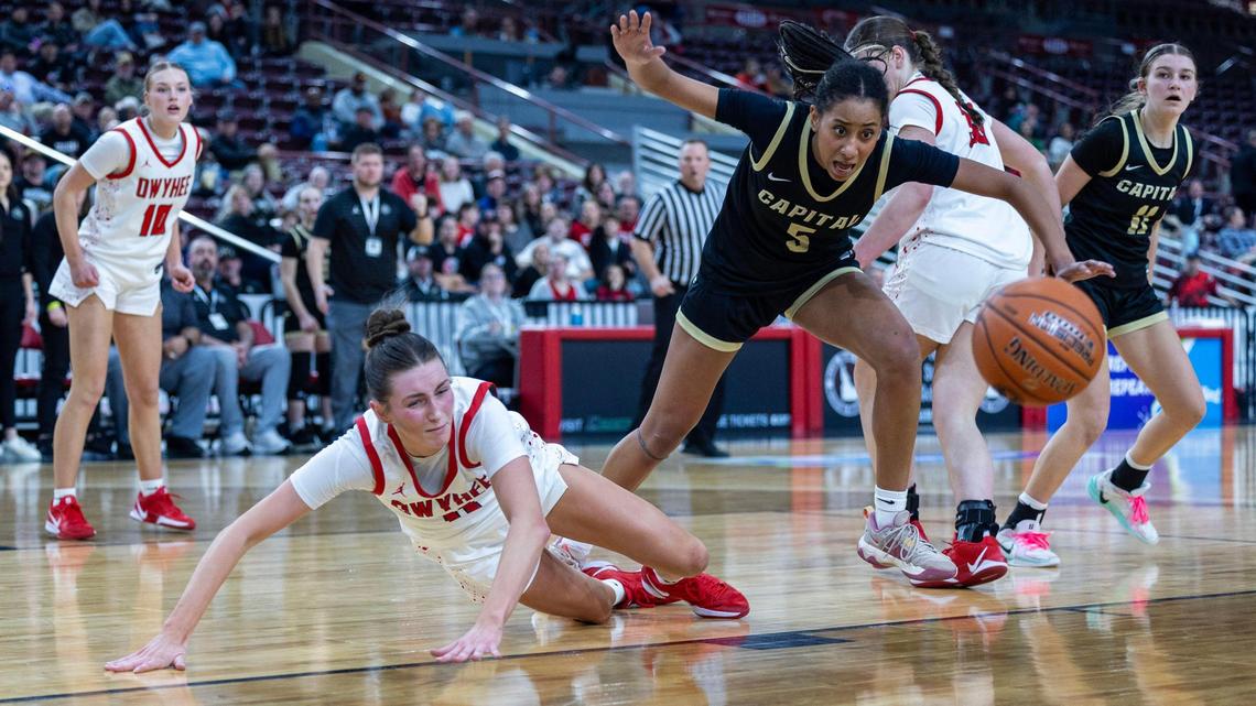 Capital junior Eden Francis, right and Owyhee’s Mikale Roy scramble for a loose ball in the first round of the 6A girls basketball state tournament Thursday.