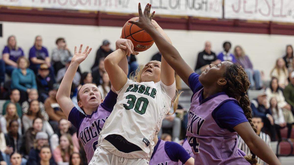 Eagle junior Berkley Jones is fouled by Rocky Mountain defenders as she attempts a shot during the semifinals of the 6A District Three girls basketball tournament held at Centennial High School, Saturday, Feb. 7, 2026.