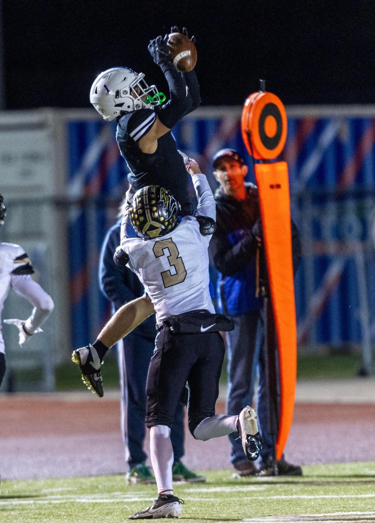 Timberline wide receiver Hudson Lewis leaps for a first-down catch against Kuna in the playoffs last season.