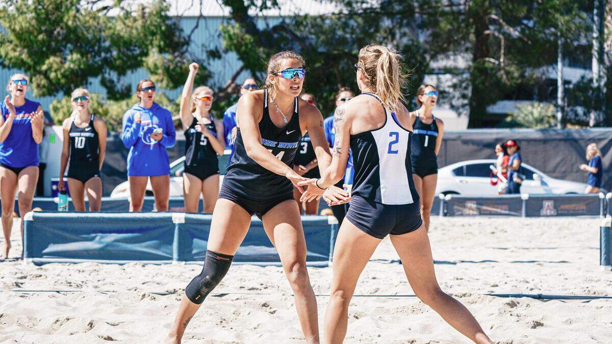 Boise State beach volleyball teammates Sierra Land (left) and Rorianna Chartier celebrate after scoring a point in a match this year. The Broncos will compete in the Southland Conference beginning this year.