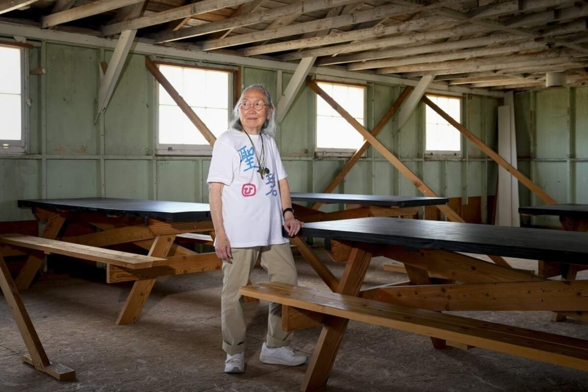 Sally Nakai Kobayashi, who was born at Minidoka in April of 1945, poses for a portrait in an original mess hall building similar to one her mother worked. Kobayashi was visiting the site with her younger sister and son for the first time since 1945, when the concentration camp closed following the end of World War II.