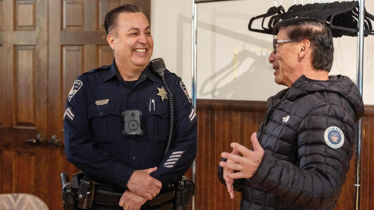 Boise Police Officer Ed Moreno talks with Tom Koto during a Coffee with a Cop event held at the Idaho Black History Museum in February. Moreno is the department’s Hispanic community liaison.