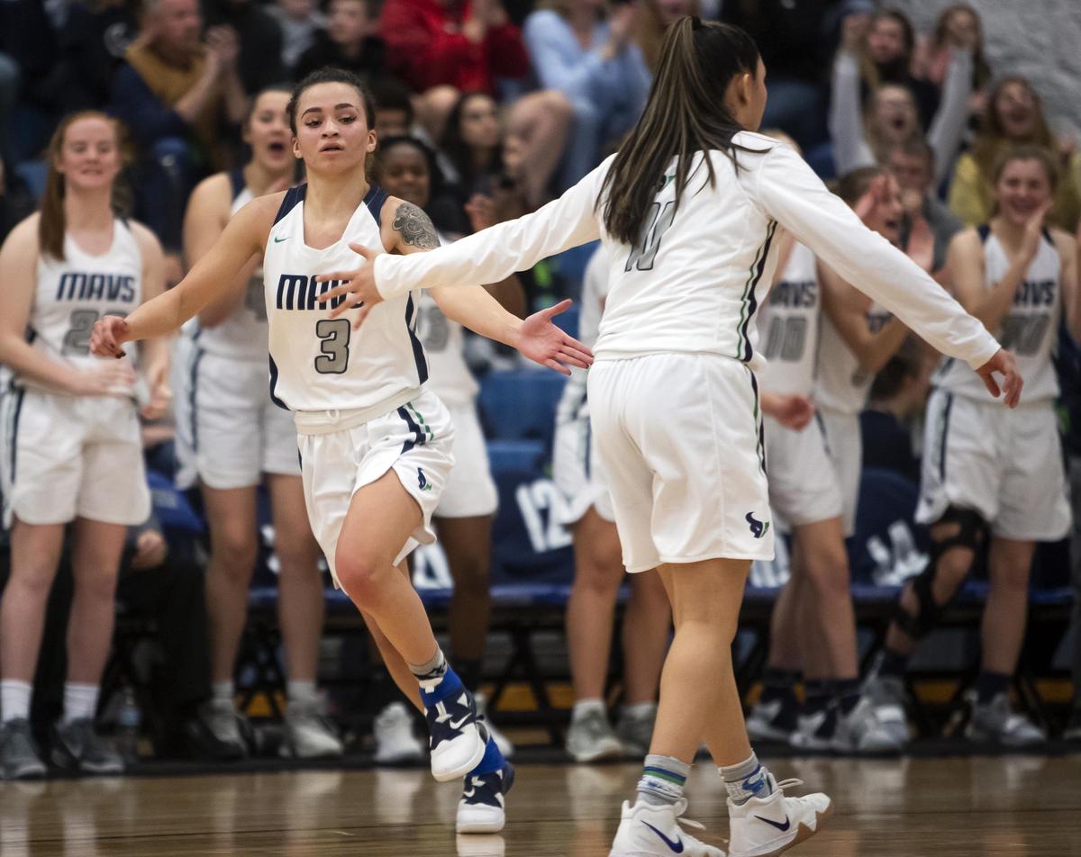 Mountain View guard Darian White gets a hand slap from teammate Laila Saenz after hitting a 3-pointer against Eagle in the 5A District Three girl’s basketball championship Friday, Feb. 8, 2019 at Timberline High School in Boise.