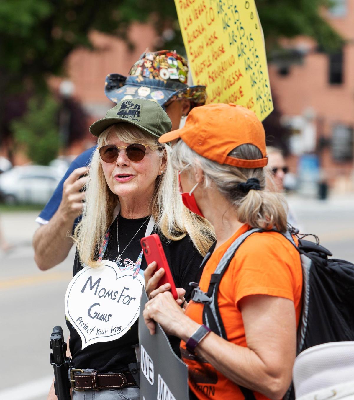 Deborah Chalmers, an Idaho gun owner, speaks with people gathered at an anti-gun violence rally in front of the Idaho Capitol in Boise on Saturday.