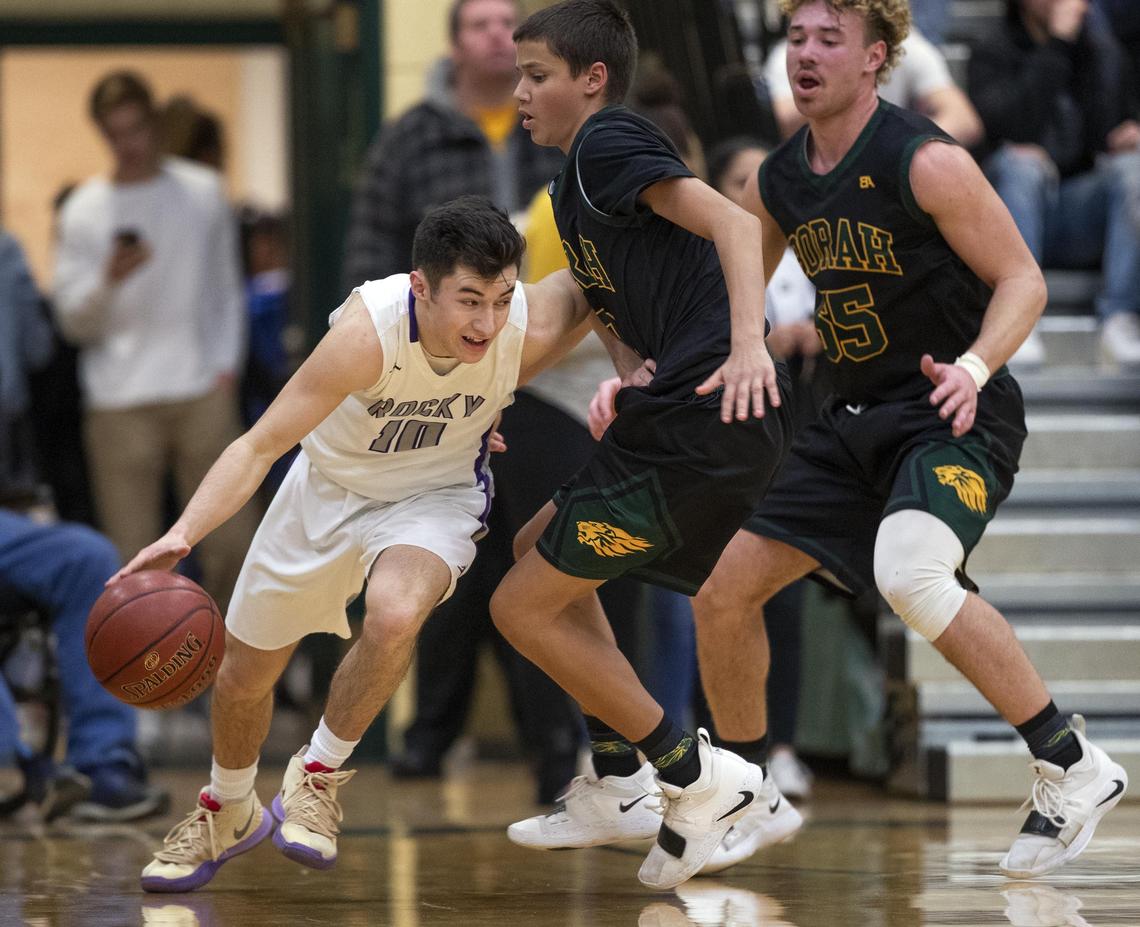 Rocky Mountain junior Cooper Frith tries to get around Borah’s Biggie Bergersen and Ellis Magnuson (55) in the 5A District Three championship game last week.