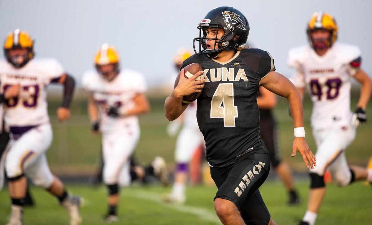 Kuna quarterback Sean Austin breaks outside of the pocket Friday against Lewiston.