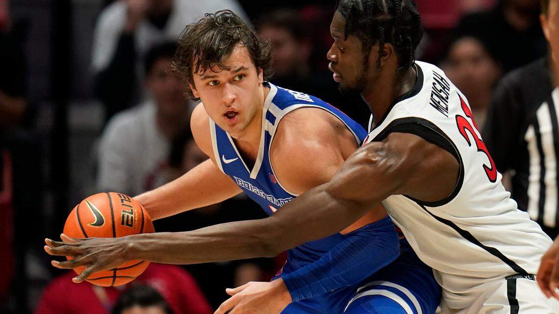 Boise State forward Tyson Degenhart, left, dribbles as San Diego State forward Nathan Mensah defends during the second half Feb. 3 in San Diego.