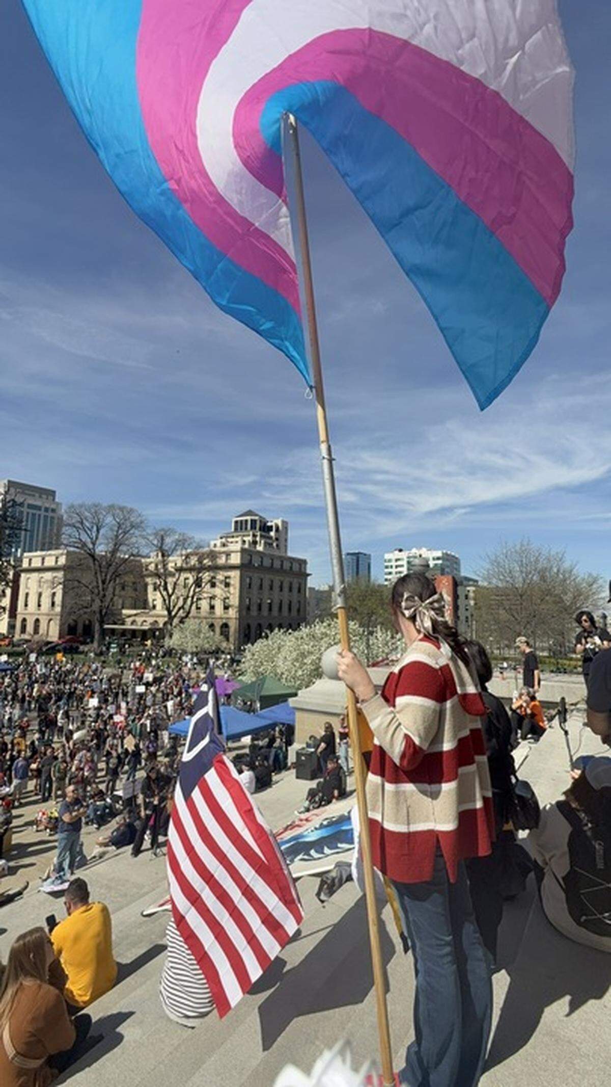Zoey Wagner of Boise flies a transgender pride flag on the Capitol steps. “I want those in power to know they’re trampling on our rights,” Wagner said. “And just because they’re using freedom of religion to do it doesn’t make it right.”&nbsp;