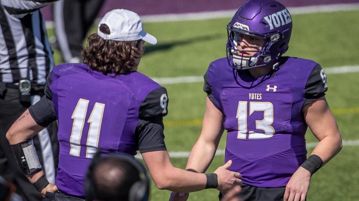 College of Idaho quarterback Jacob Holcomb (13) is congratulated by his older brother, Nathaniel Holcomb, also a quarterback, after throwing a touchdown pass against Montana State-Northern Saturday, March 13, 2021 in the Yotes’ spring season Frontier Conference opener at Simplot Stadium in Caldwell. C of I won the game 26-12.