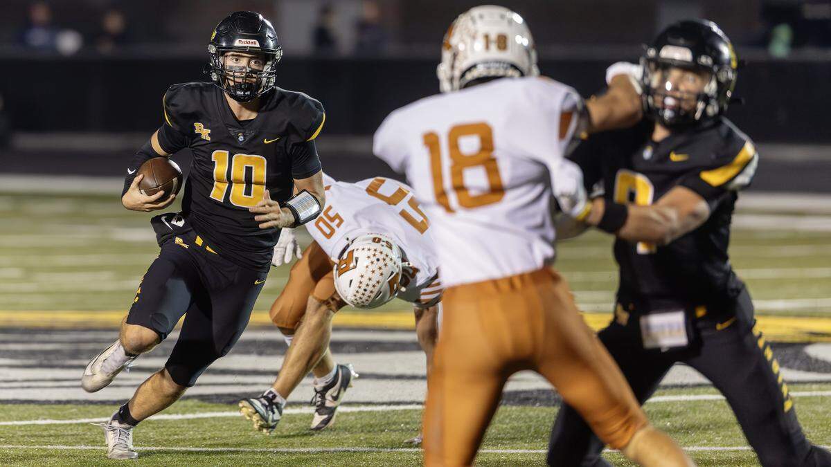 Bishop Kelly senior quarterback Ben Avella keeps the ball during their football game at home against Ridgevue, Friday, October. 17, 2025.