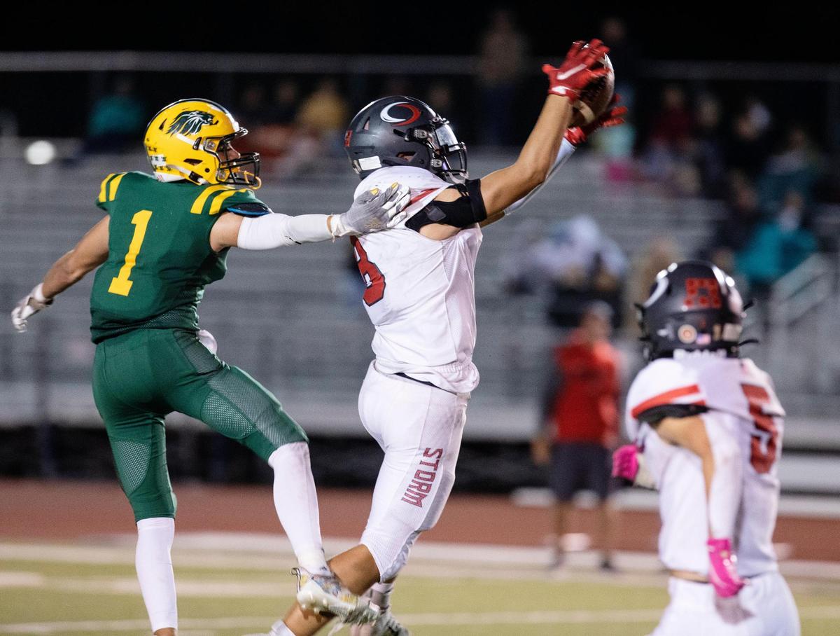 Owyhee’s Cooper Hiatt intercepts a pass intended for Borah’s Bradly Toth at Dona Larsen Park.