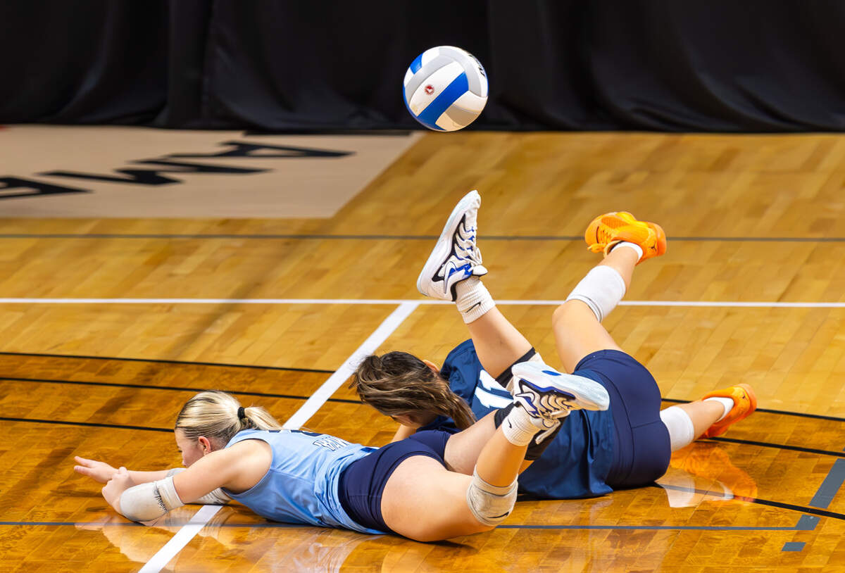 Skyview junior Kensie Seward, left, and sophomore Chloe Lin, right, collide as they both dive to save the ball Saturday during the 6A volleyball state tournament at the Mountain America Center in Idaho Falls. Madison defeated Skyview 3-1 to claim the state title.