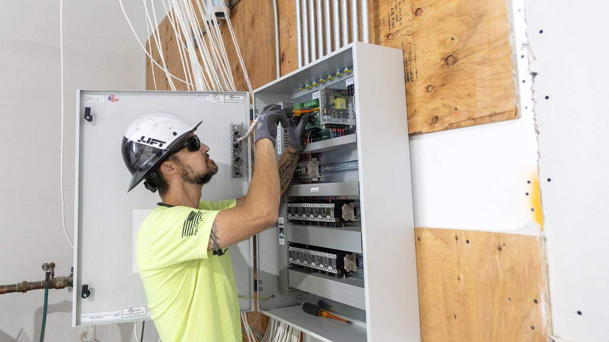 John Calamaro, an Idaho journeyman electrician, works inside a commercial business Tuesday in Meridian. “We’re booming here in the Treasure Valley, and we don’t have enough journeymen,” he said, referring to a state exam that had an 18% pass rate over the past year.