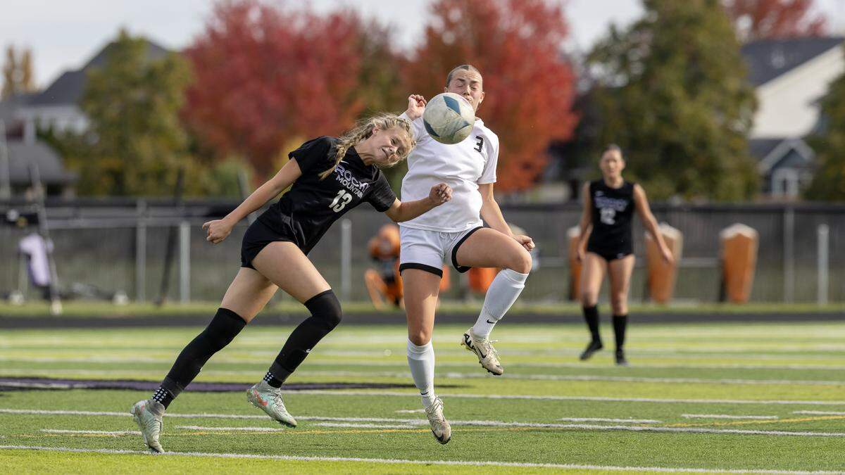 Rocky Mountain freshman Reagan Hom heads the ball in front of Boise junior Lucy Hopstad in their semifinal game held at Rocky Mountain, Friday, Oct. 24, 2025.