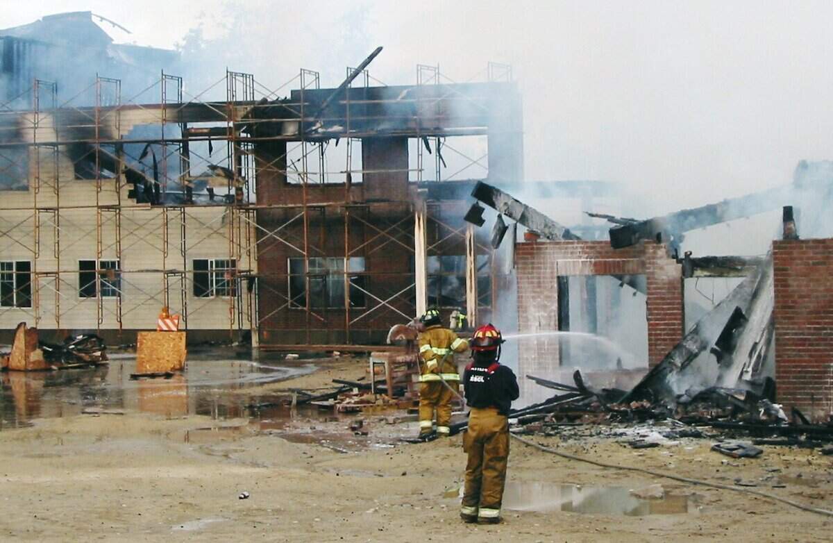 Firefighters douse the remains of the Villa Highlands Luxury Retirement building at 15th Street and Hill Road in 2006.