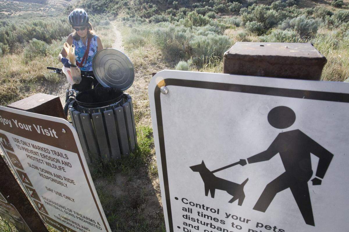 A volunteer deposits a bag full of dog poop collected at Big Springs trailhead near Horseshoe Bend Road in Eagle.