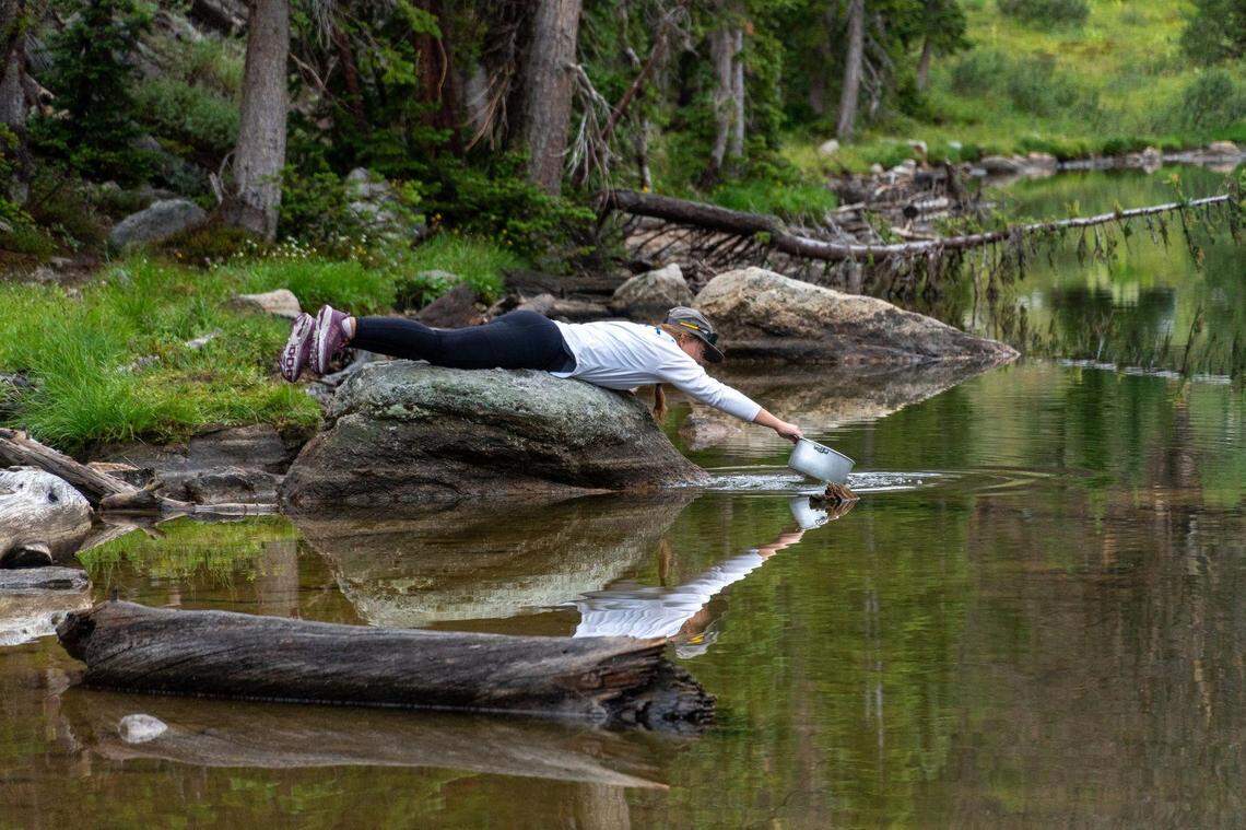 Sarah Kirchner, trip leader, fills a pot with water to boil for dinner during an overnight backpacking trip with CSI’s Outdoor Recreation Center on Saturday evening, July 31, 2021, in the Salmon-Challis National Forest near Sun Valley.
