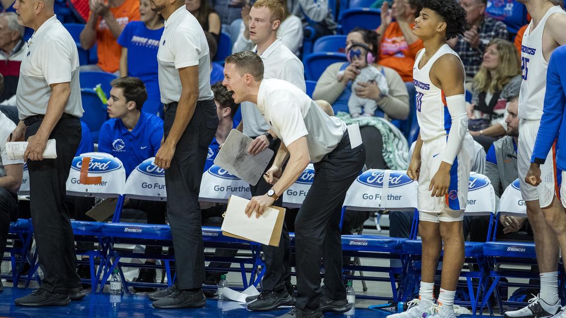 Boise State men’s basketball graduate assistant James Reid, a former player, cheers from the bench during the Broncos’ game against BYU on Nov. 20 at ExtraMile Arena. “It’s great to have him around. He’s a huge asset and gives me a good player’s perspective on a lot of things,” coach Leon Rice said.