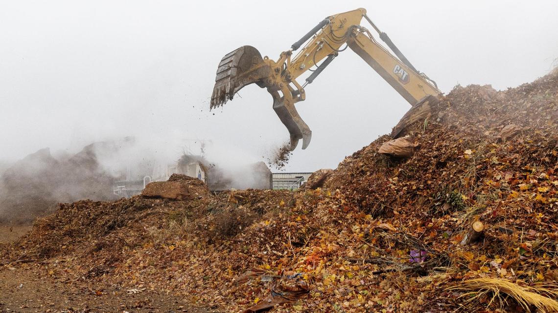 Organic waste is picked up by machinery to be run through a grinder at Timber Creek Recycling, Nov. 21, 2024. Timber Creek is planning to decommission its site in Meridian while shifting operations to a new site in Nampa. Neighbors have complained about smells from the compost site.