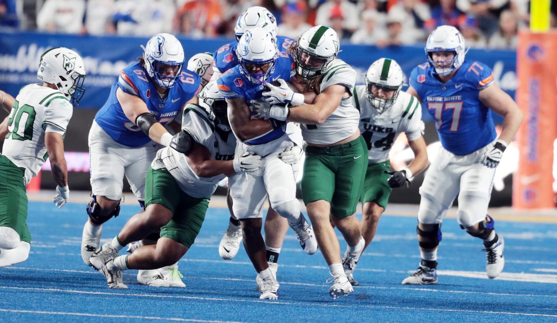 Boise State running back Sire Gaines runs through the Portland State defense. Boise State defeated Portland State 56-14 at Albertsons Stadium in Boise, Idaho.