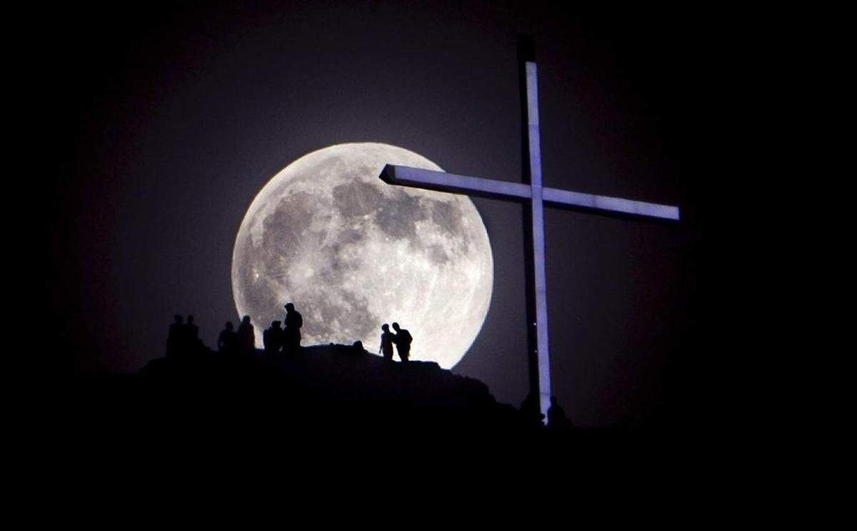 A “supermoon” rises over Table Rock and its lighted cross near Boise in June 2013. Table Rock is one of Boise’s most well-known landmarks.