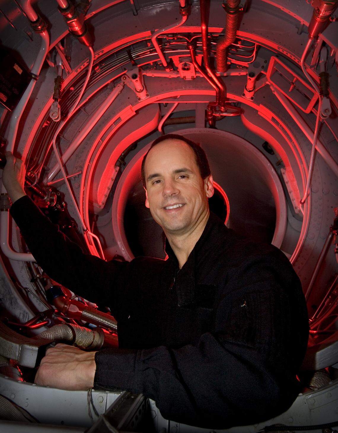 FILE - In this Dec. 12, 2005 file photo, Steve Appleton, CEO and chairman of Micron Technology Inc., looks out through the engine compartment of his stunt jet airplane inside the hanger where he keeps several different types of aircraft in Boise, Idaho. Appleton, has died in a small plane crash Friday, Feb. 3, 2012, in Boise. He was 51. (AP Photo/Troy Maben, File