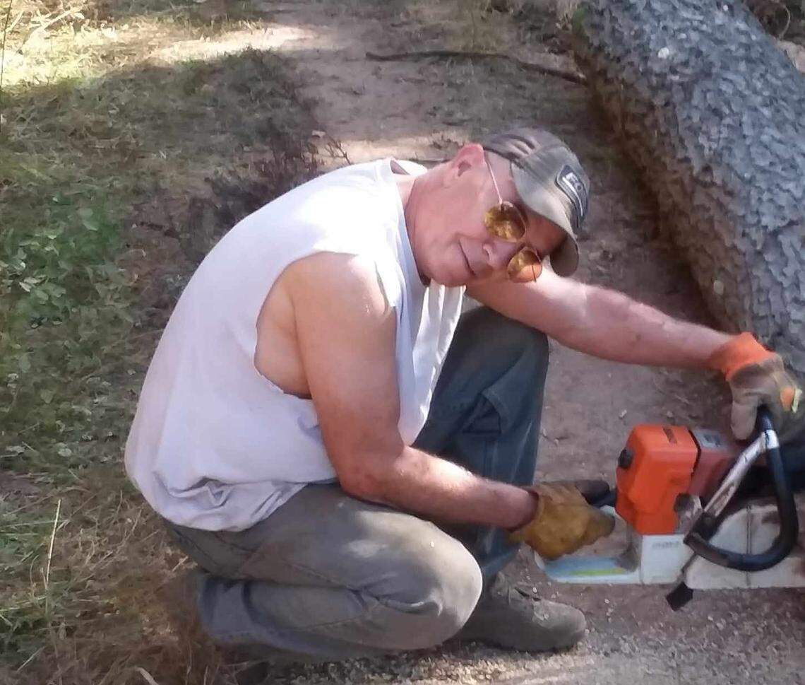 Don Henderson is seen preparing firewood outside his North Idaho cabin. The 72-year-old was killed by Skylar Meade and Nicholas Umphenour.