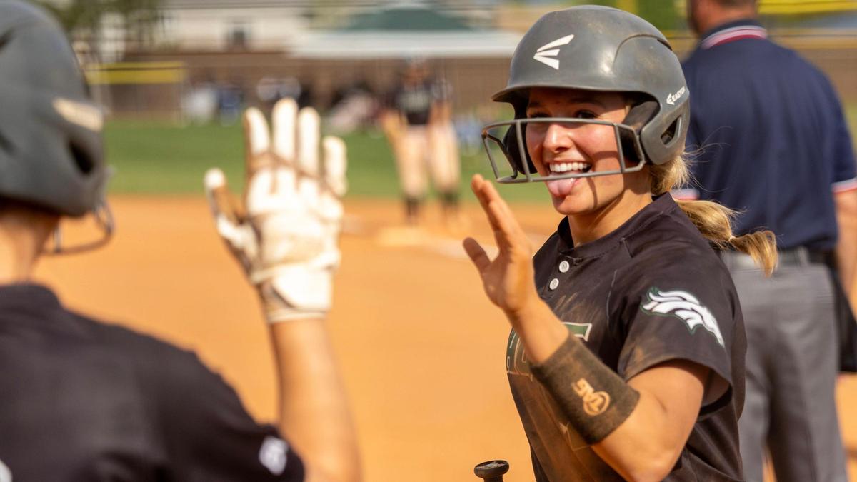 Eagle’s Ellie McManigal gets a high-five from a teammate after an RBI single in the 6A state semifinals last season. 
