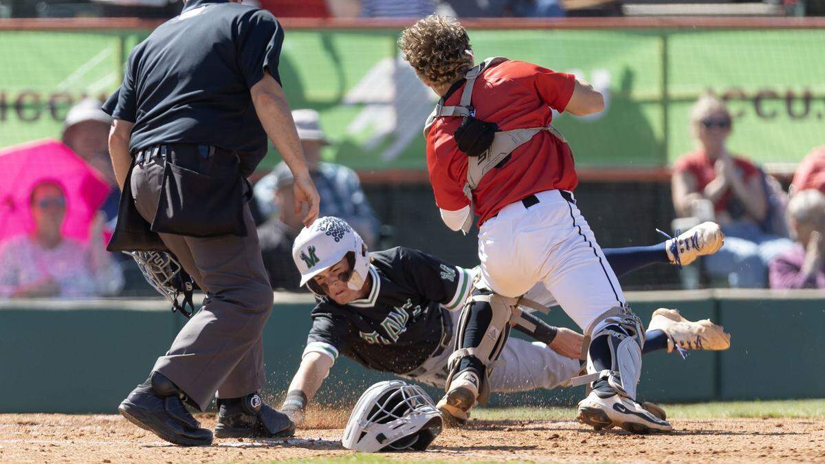 Mountain View base runner Cooper Schneidt slides under the tag of Owyhee catcher Nathan Keith for a run on day two of the 6A baseball state tournament at Memorial Stadium in Boise, Friday, May 15, 2026.