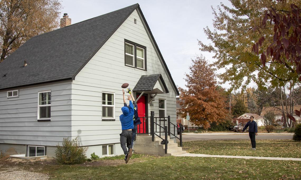 Boise State students Mitchell Bandy, left, and Michael Richardson play offense-defense with their friend J.D. Johnson. Bandy and Richardson live in a single-family home with two other roommates on Grant Street near campus. The SouthEast Neighborhood Association would like to preserve and encourage homes like this one that are suitable a mix of students, families and professors, instead of dorm-like duplexes designed with four or five bedrooms per side.