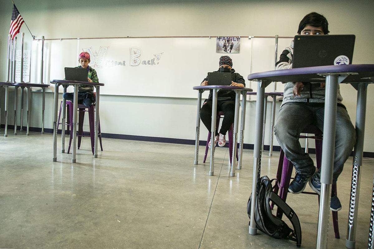 Students work at tables spread out at Elevate Academy, a year-round charter school in Caldwell.