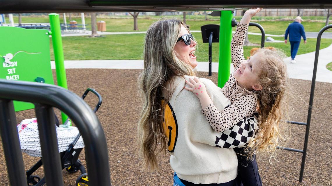Cali Spears helps her daughter Ivy, 4, play at a neighborhood park in Meridian. The city used federal funds to renovate the play structure and is asking for feedback for how to use the funds this year.