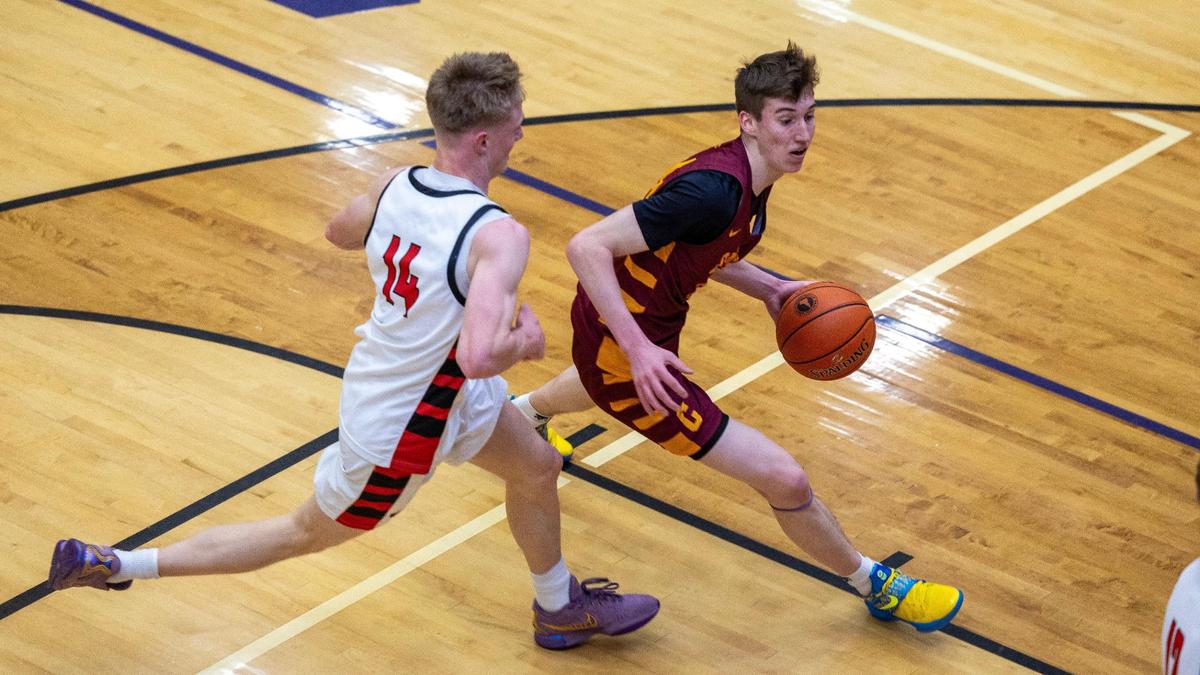 Columbia’s Max Keller dribbles the ball past a Hillcrest defender during the first round of the 5A boys basketball state tournament last season at Rocky Mountain High School in Meridian.