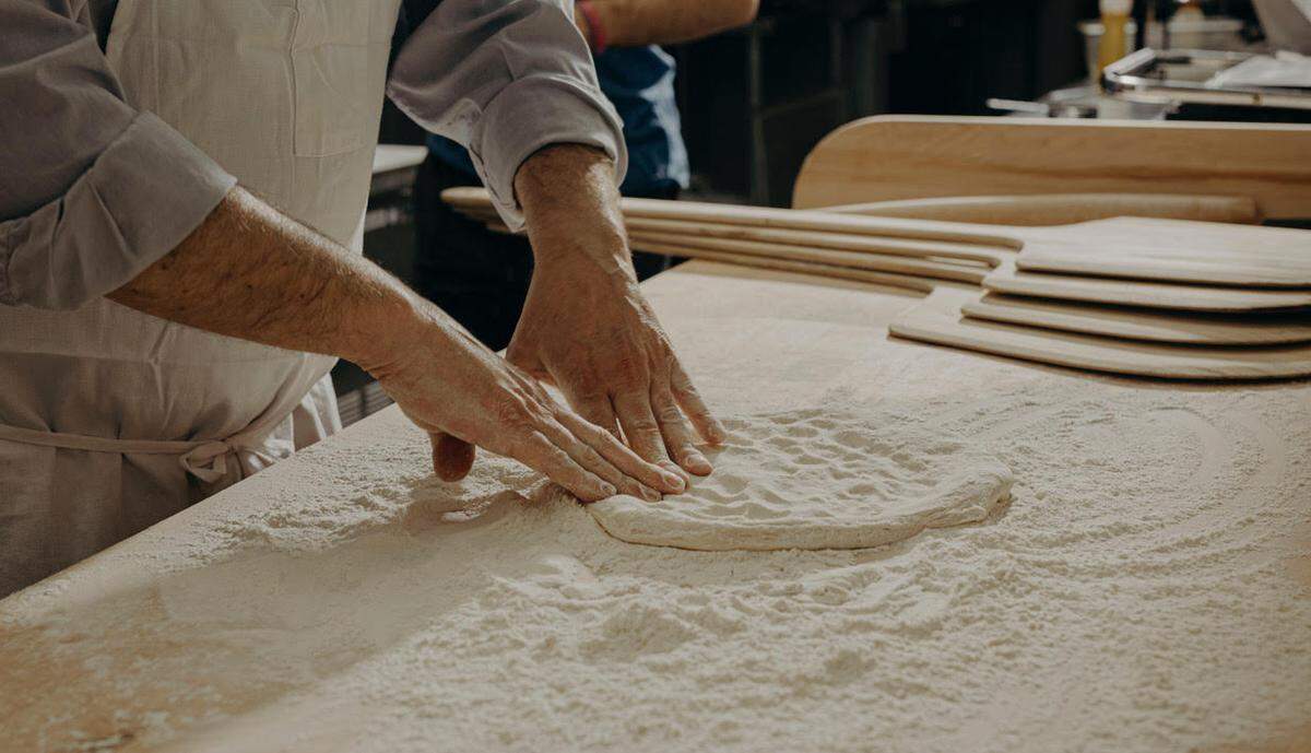 A pizza crust takes shape at Casanova Pizzeria.