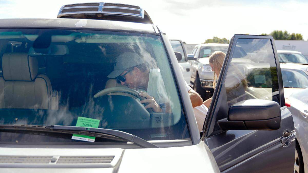 Steve Hale scopes out the inside of a Land Rover as he and his daughter, Brooklyn, 15, browse for options for her first car.
