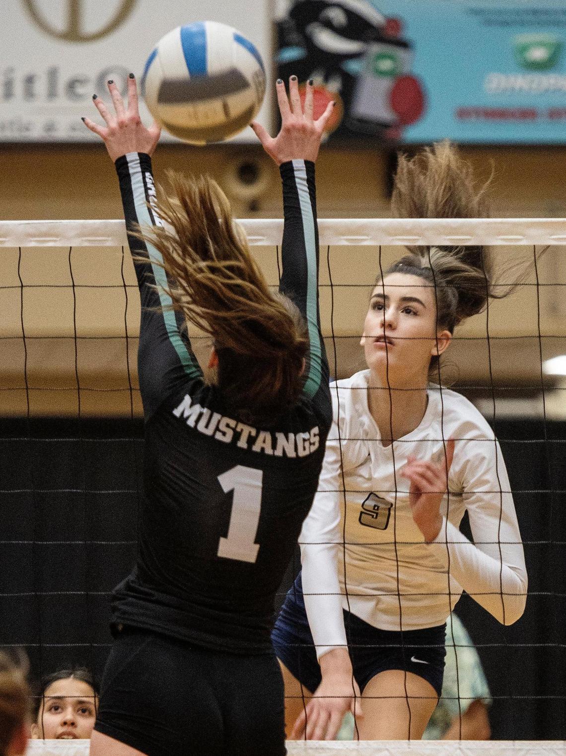 Skyview’s Alex Acevedo spikes the ball past Eagle’s Gabbi Roberts on Tuesday at Northwest Nazarene University’s Johnson Center in Nampa.