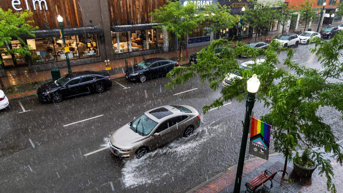A vehicle splashes through a flooded area of downtown Boise during a flash thunderstorm that dropped up to 1.5 inches of rain in less than 90 minutes in parts of downtown Tuesday night. Hail was also reported.