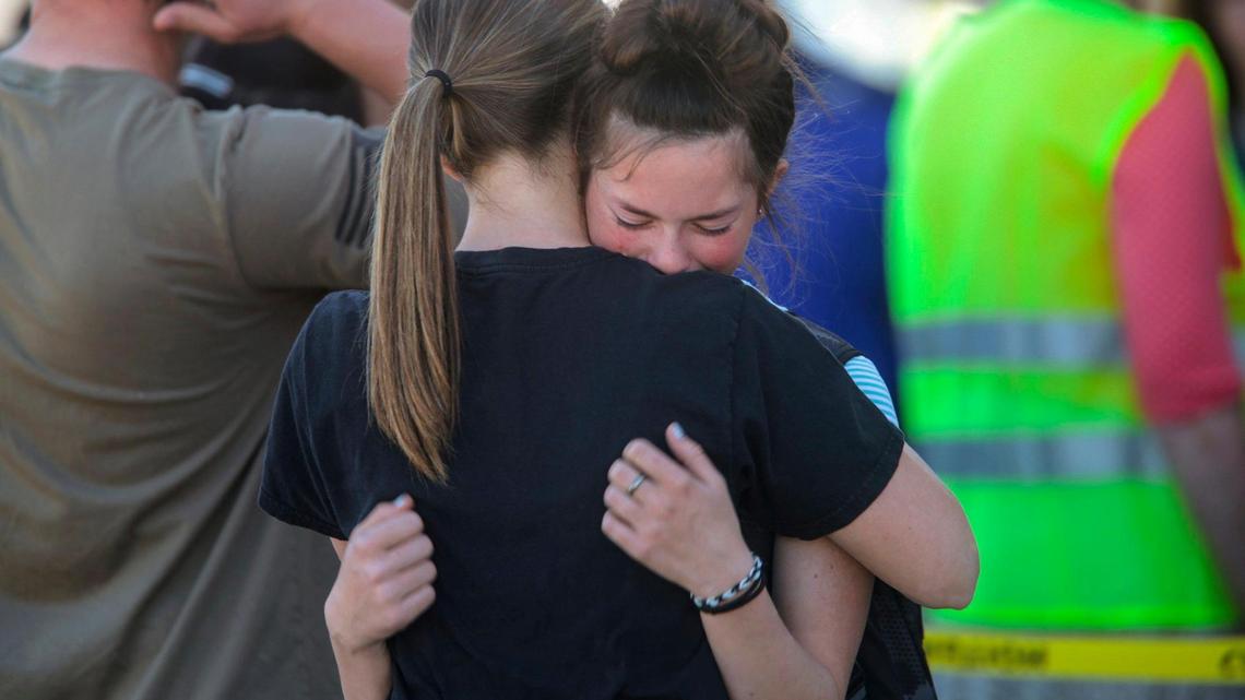 Students embrace after a school shooting at Rigby Middle School on Thursday. Authorities said three people were injured, two of them students, and a student was taken into custody.