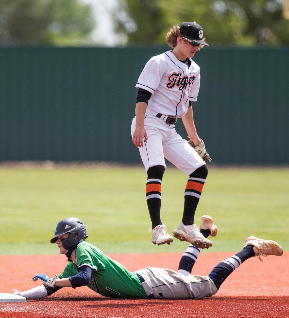 Mountain View’s Logan Burrell slides safely into second with a stolen base as Idaho Falls second baseman Nate Rose hops over him Thursday at Wolfe Field in Caldwell.