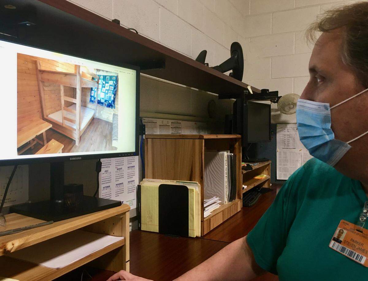 Steven Parker, who has completed an 8,000-hour drafting apprenticeship at Idaho Correctional Industries, shows off the bunk beds he designed for a state park. “The real value in this is when we get on the other side of the fences,” he said, referring to the prison’s security fencing.