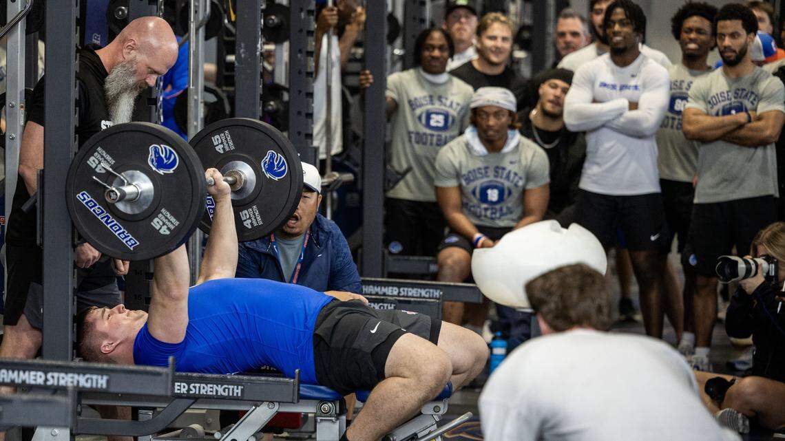 Former Boise State offensive lineman Kage Casey bench presses in front of a group of NFL scouts and cheering teammates at Pro Day at the Caven-Williams Sports Complex in Boise, Tuesday, March 24, 2026.