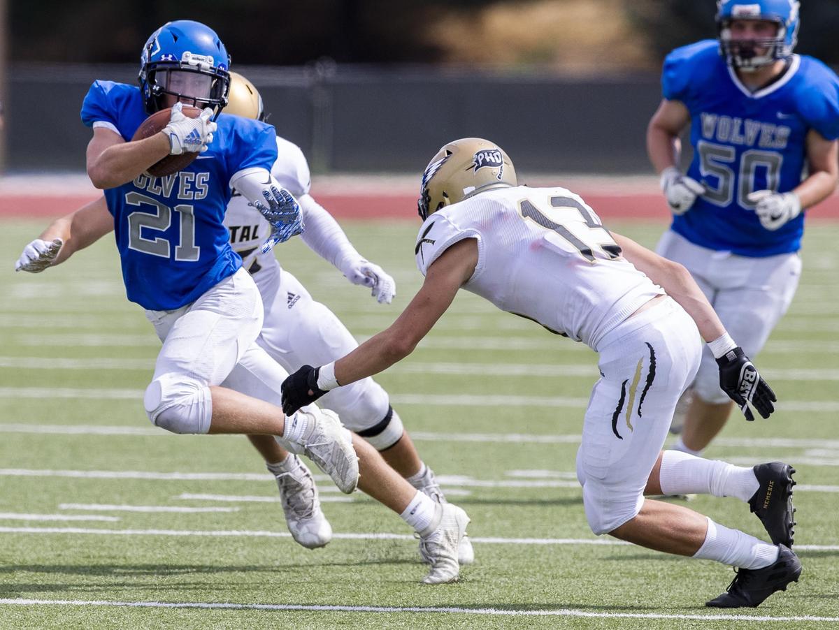 Timberline running back Taylor Marcum zigs and zags through Capital’s defense last season at Dona Larsen Park.