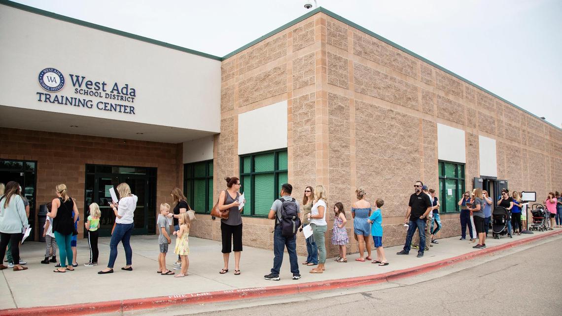 Parents in the West Ada School District, some with their children in tow, line up around the administration building. West Ada school board chairman Rusty Coffelt submitted his resignation letter four months after assuming the role.