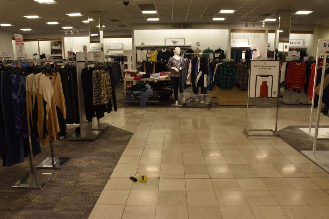 A gun clip lying on the ground among racks of clothes at the scene of the Boise Towne Square Mall shooting in October 2021.