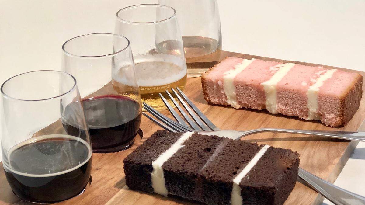 One the right are slices of Mexican mocha chocolate cake with chocolate ganache and buttercream filling, and strawberry cake with champagne buttercream filling. At left, glasses of beer, red wine, champagne and cider.