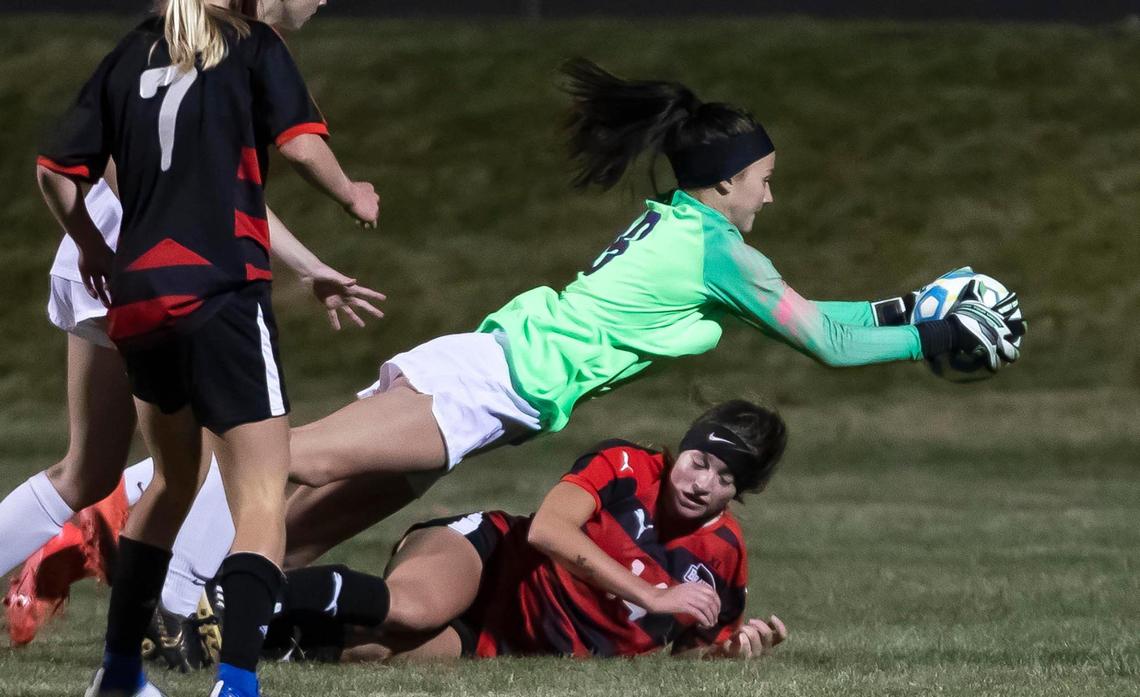 Rocky Mountain goalkeeper Kasey Wardle secures the ball, diving over Boise’s Kayden Hulquist, on a chaotic series in front of the net Tuesday at Middleton High School.
